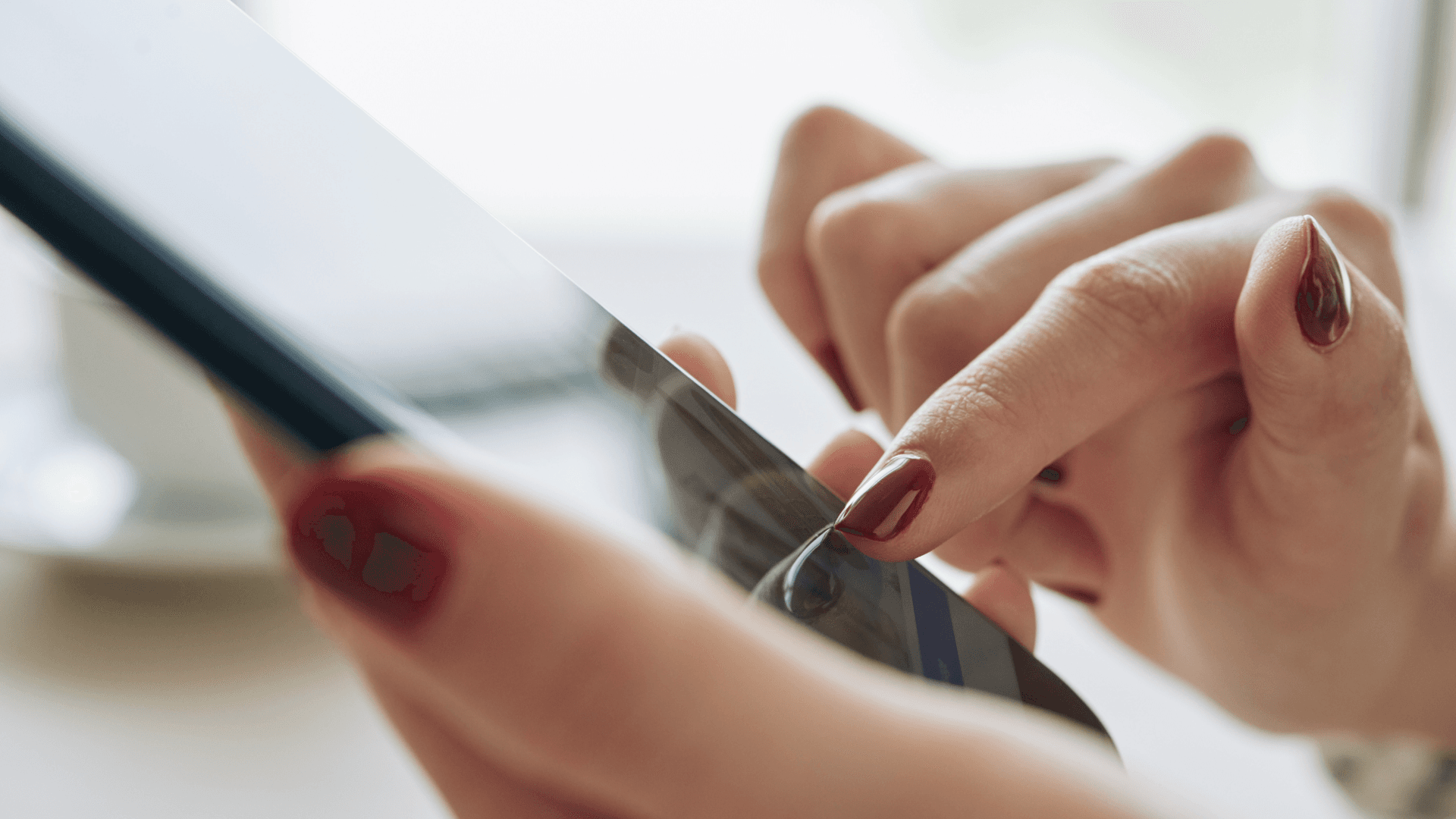 Close-up of hands using a smartphone, representing user interaction with mobile applications monitored by Azure App Insights.