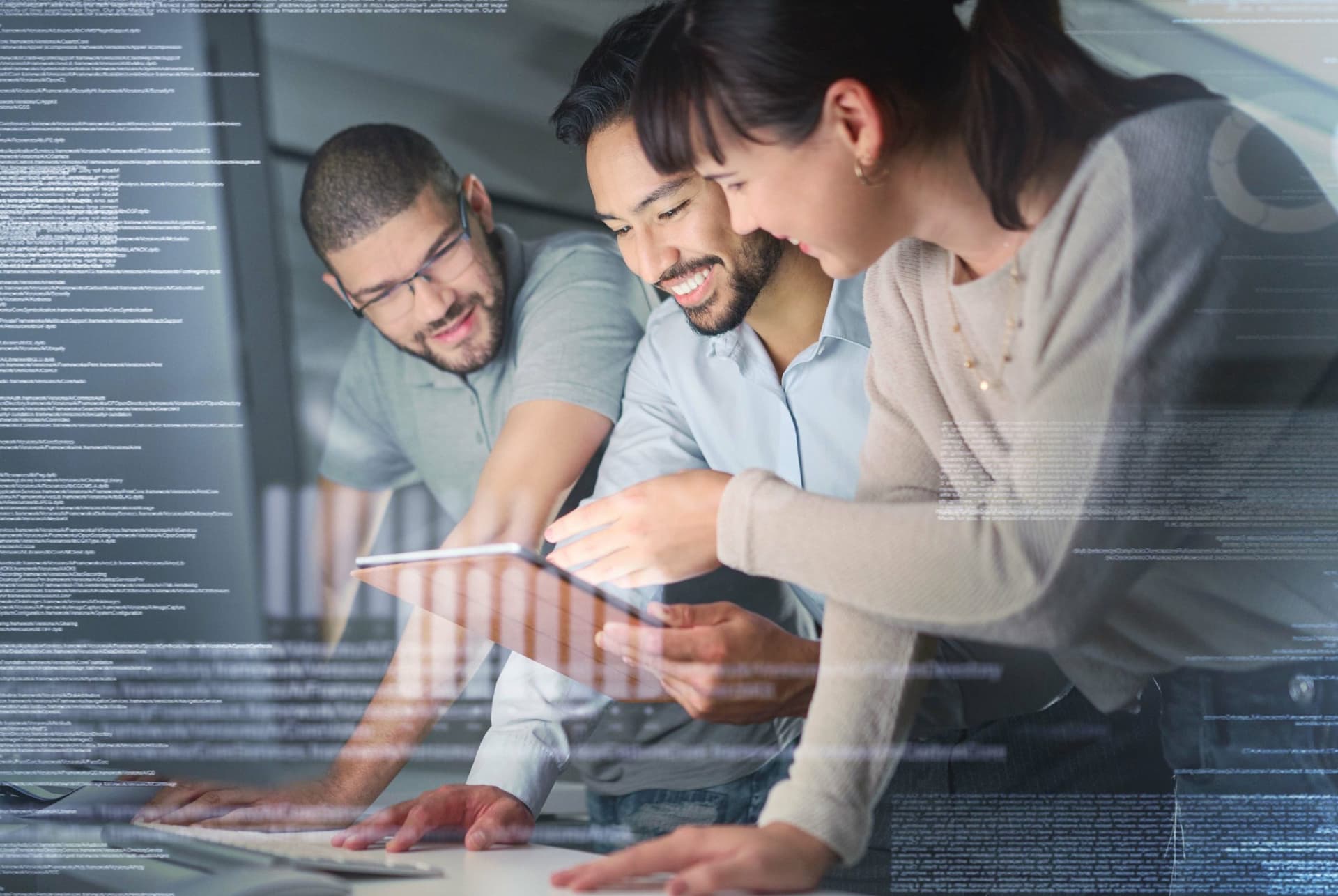 Three people collaborating while looking at a tablet, with code overlay suggesting teamwork in software development.