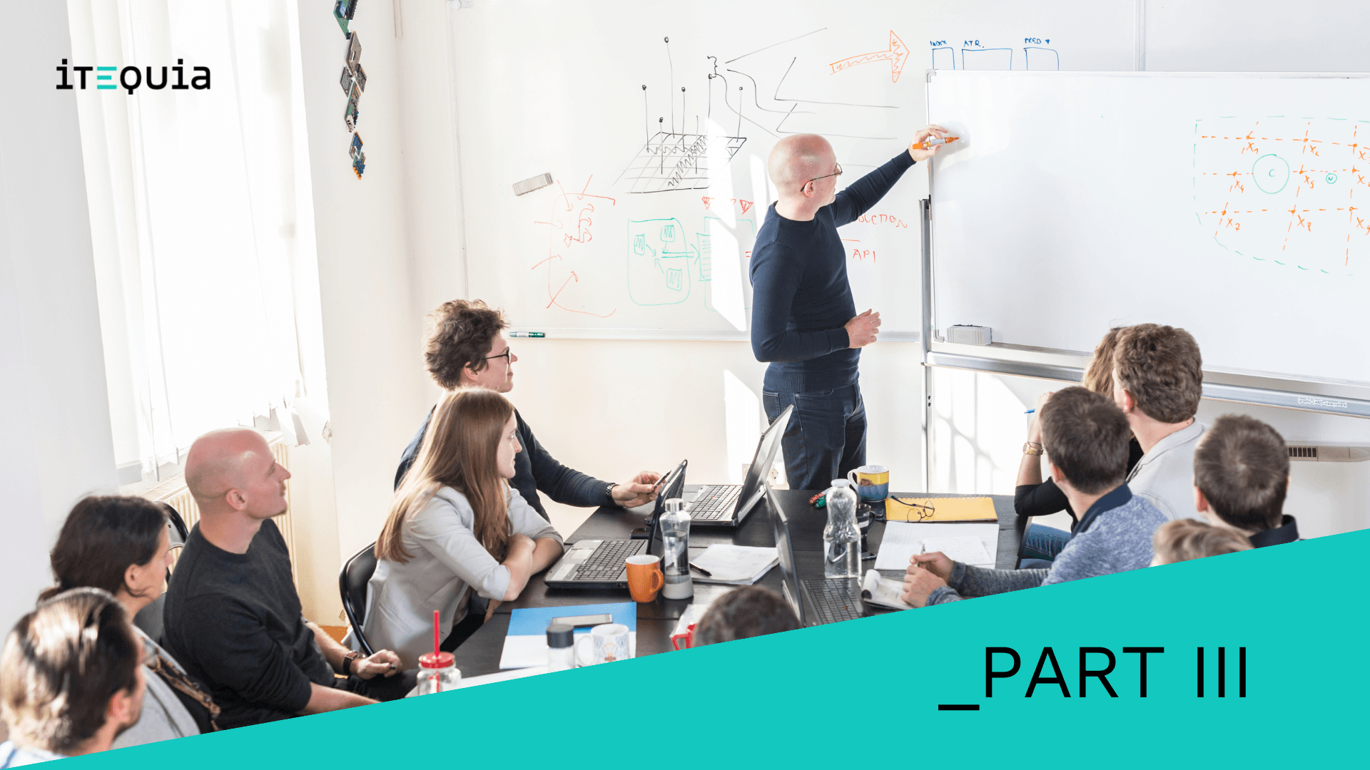 Team collaborating in a meeting room with one person writing diagrams and notes on a whiteboard, discussing multi-tenant strategies.