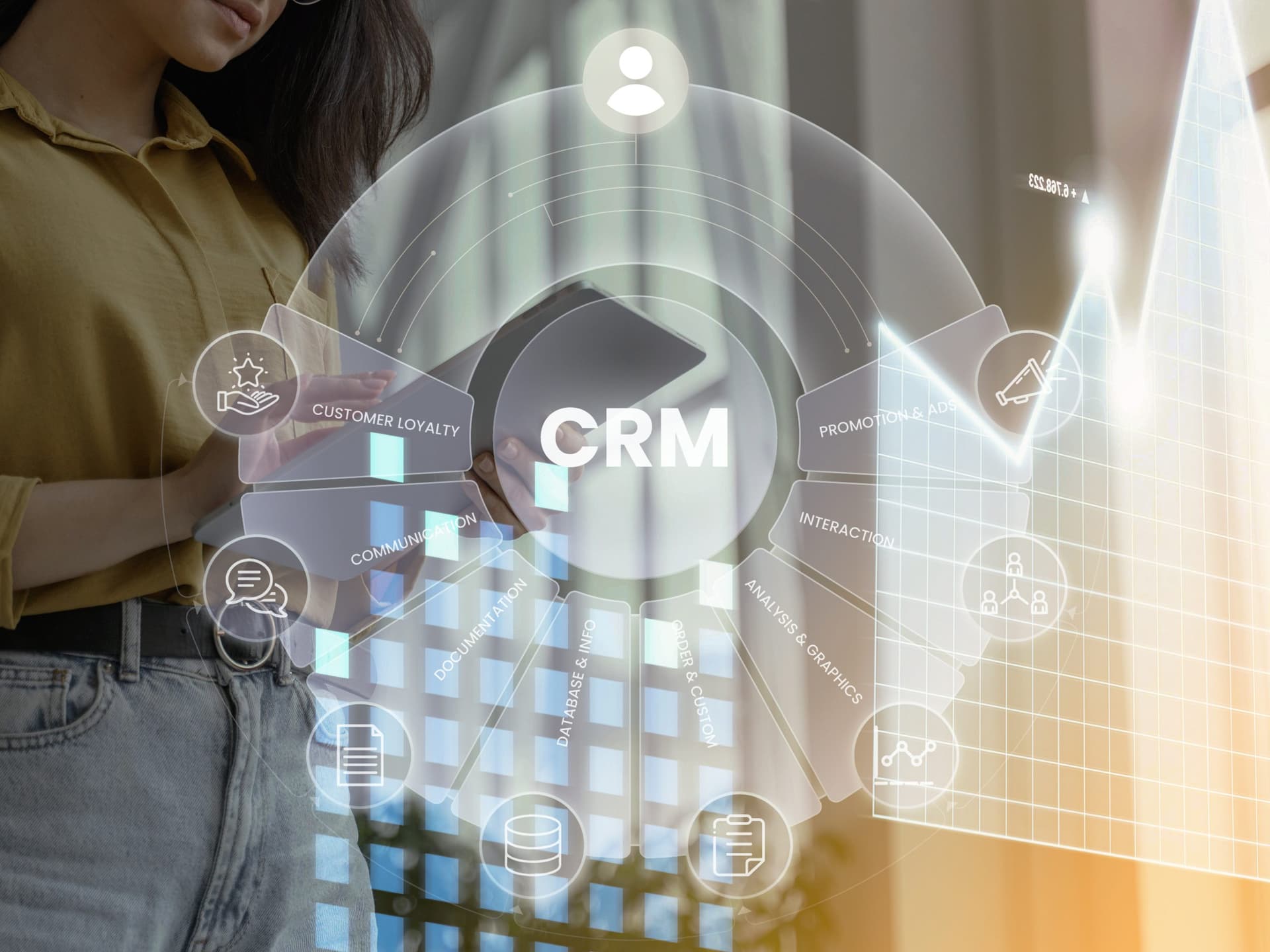 Person holding a tablet with an overlaid circular CRM interface showing segments like customer loyalty, promotion and sales, interaction, analysis, data storage, and communication, alongside a growth chart.