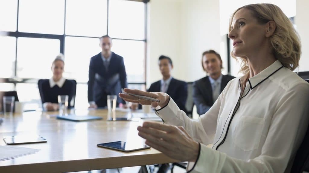 Businesswoman gesturing in conference room meeting