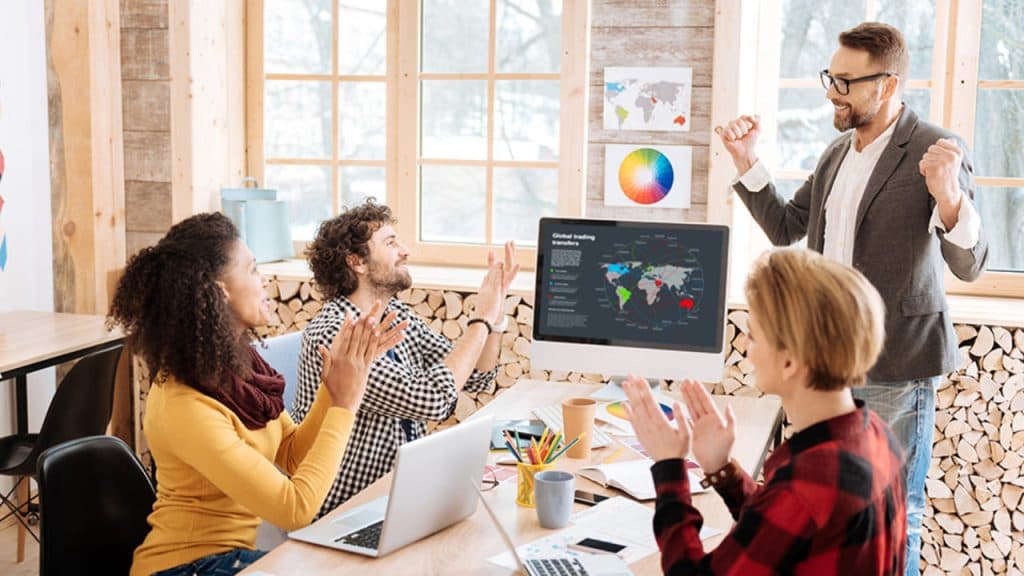 Happy employees clapping to their boss