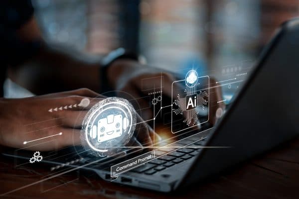 Person typing on a laptop with digital holograms representing artificial intelligence concepts in software development