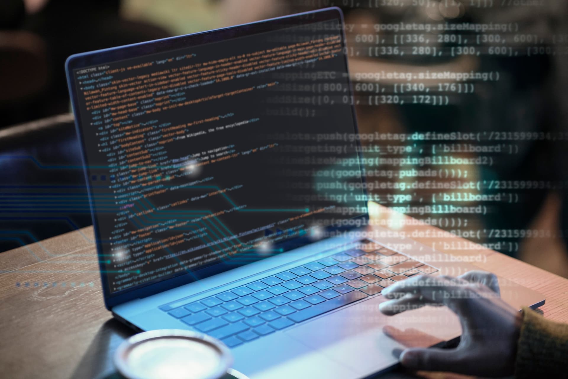 Laptop on a wooden desk displaying code, with a hand typing and digital code overlays, representing Microsoft’s new AI agents in Security Copilot.