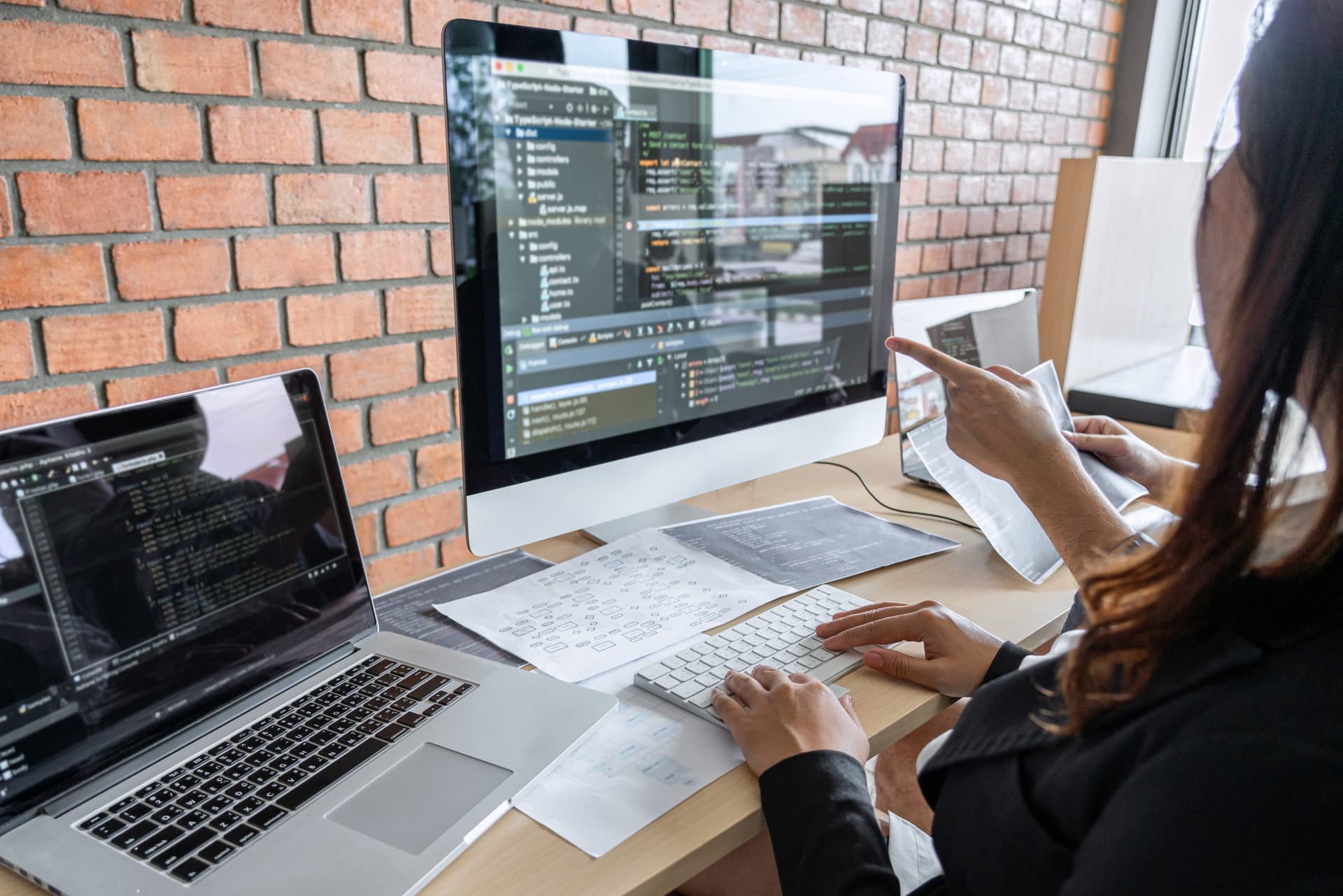 Two professional programmer cooperating and working on web site project in a software developing on desktop computer at company, codes and typing data code, Programming with HTML, PHP and javascript.