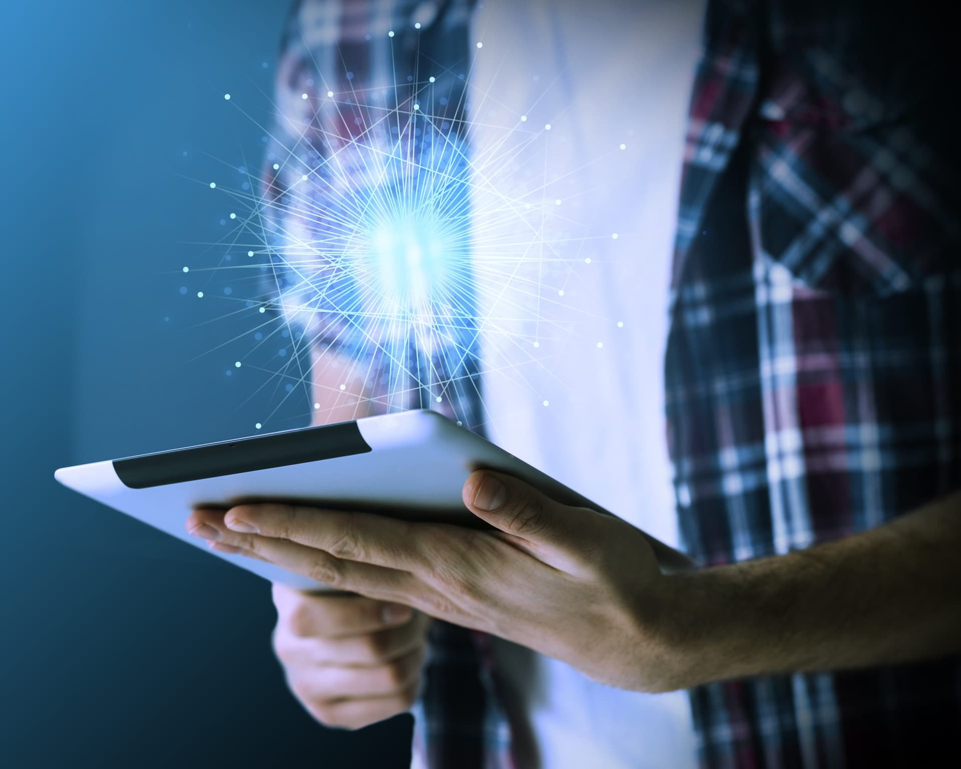 Person holding a tablet with a glowing digital network graphic above it, representing technology and digital transformation with Microsoft Dynamics 365 CRM.